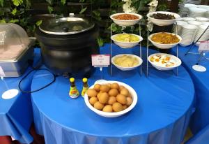 a blue table with bowls of food on it at Palette The Travellers Hotel Bangkok in Bangkok