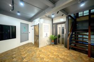 a hallway with a staircase and a stair case at Episode 11 Hostel Sukhumvit in Bangkok
