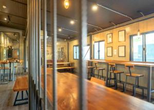 a restaurant with a long wooden table and bar at Episode 11 Hostel Sukhumvit in Bangkok +75 photos