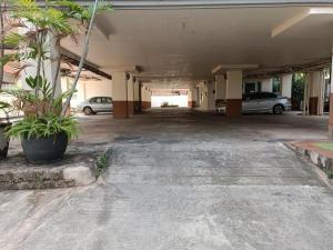 an empty parking garage with cars parked in it at Grandview Condominia in Bangkok