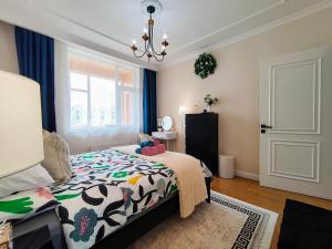 a bedroom with a bed with a cow patterned blanket at Tsengeldekh:Cozy 1 BR Apt•Queen bed•Naadam stadium in Ulaanbaatar +20 photos