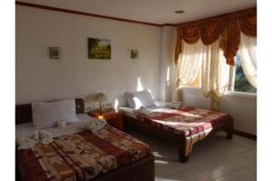 Postel nebo postele na pokoji v ubytování Marian Palazz Hotel