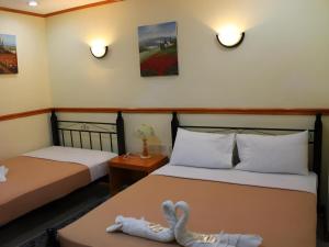 Postel nebo postele na pokoji v ubytování Marian Palazz Hotel