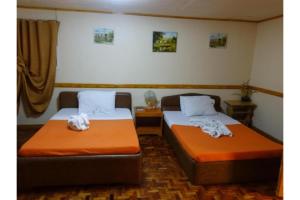Postel nebo postele na pokoji v ubytování Marian Palazz Hotel