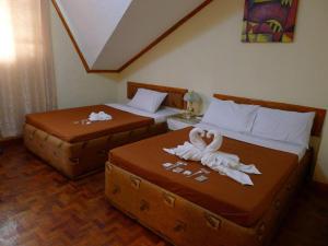 Postel nebo postele na pokoji v ubytování Marian Palazz Hotel