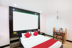 a bedroom with a large bed with red pillows at OYO 195 Ranchotel - Biñan in Biñan
