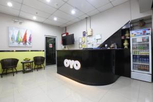 a lobby of a store with a ovo counter and chairs at Hotel O Destiny Riverside Hotel in Kota Bharu