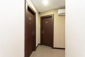 an empty hallway with two doors and a hallwayngth at Capital O 89344 Labuan Avenue Hotel in Labuan +37 photos
