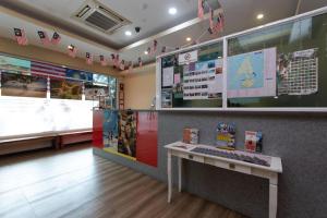 a waiting room with a desk and a keyboard at Capital O 89344 Labuan Avenue Hotel in Labuan