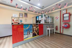 a room with a counter with flags on the wall at Capital O 89344 Labuan Avenue Hotel in Labuan
