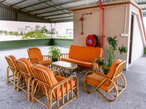 a group of chairs and a couch and a table at Capital O 89344 Labuan Avenue Hotel in Labuan