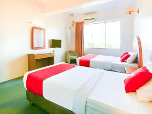 a hotel room with two beds and a television at Hotel O My Hotel in Segamat