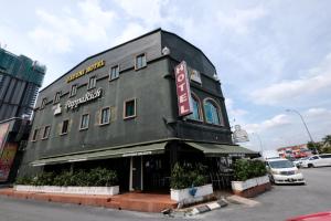 a black building on the corner of a street at Hotel O Ayuni Hotel in Bangi