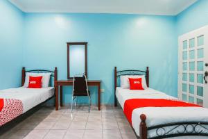 Postel nebo postele na pokoji v ubytování OYO 44094 Bangi Lanai Hotel + 37 fotografií