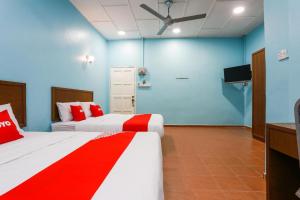 Postel nebo postele na pokoji v ubytování OYO 44094 Bangi Lanai Hotel
