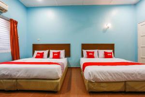 Postel nebo postele na pokoji v ubytování OYO 44094 Bangi Lanai Hotel