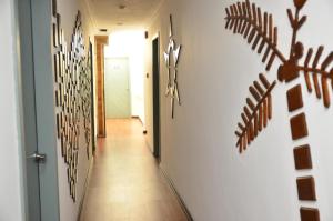 a hallway with christmas decorations on the walls at Hotel O Five 2 in Kota Kinabalu