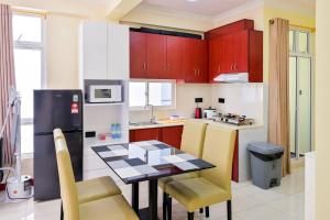 a kitchen with a table and a refrigerator at Air Residence 10813 in Hulhumale