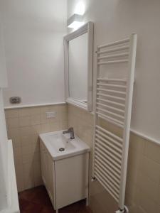 a white bathroom with a sink and a mirror at Riviera 1683 - Centro storico e mare! in Chiavari +16 photos