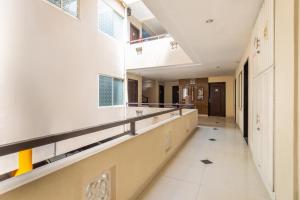 an empty hallway in a school building with windows at Hotel O Surabaya City Center Near Wonokromo Station in Surabaya