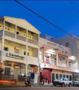 a building with a car parked in front of it at Central Hotel in Morondava