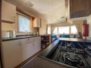 Una cocina o zona de cocina en Homely 8 Berth Caravan With Side Decking And Ramp Access In Kent, Ref 47018H