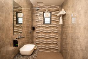 a bathroom with a sink and a toilet in it at Daksh The Grand Goverdhan in Dwarka +61 photos