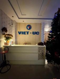 a white tub in a room with a christmas tree at khach san viet uc in Vinh