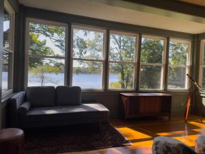 a living room with a couch in front of windows at Vanderkamp in Cleveland +24 photos