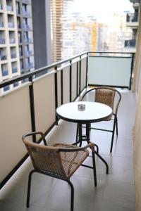 a table and two chairs on a balcony at Cozy Apartment Near The Beach in Kakhaberi