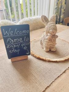 a sign and a stuffed rabbit next to a sign at 2025 Traveller award winner Just bring clothes in West Kirby