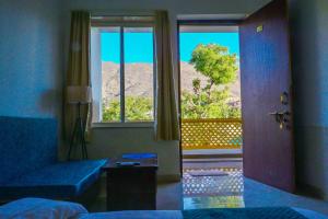 una camera con un letto e una porta con finestra di Hariom Tatsat Retreat a Pushkar Altre 55 foto