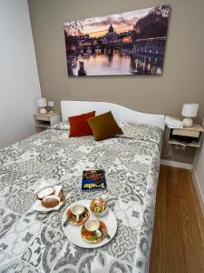 a bed with a tray of food on it at GioLu Colosseo in Rome +20 photos