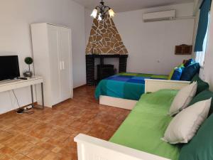 a bedroom with two beds and a fireplace at Studio Tropical in Cúllar-Vega