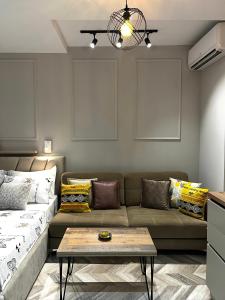 a living room with a couch and a table at Family Adventure at Pazar in Tirana