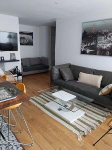 a living room with a couch and a glass table at Appartement la défense Courbevoie in Courbevoie