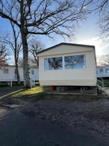 a small white house with a large window at Beachlands in Porchfield