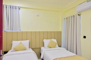 two beds sitting next to each other in a room at Air Residence 10813 in Hulhumale +8 photos