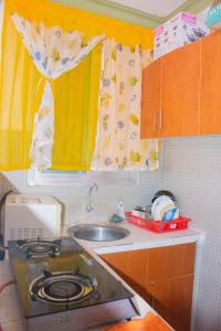 a small kitchen with a sink and a stove at Bamburi Luxury Homes II One bedroom apartment in Bamburi