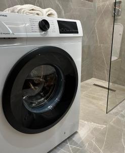 a white washing machine sitting in a room at Family Adventure at Pazar in Tirana