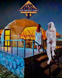 a man and a woman walking down the stairs at RUM FANTAS BUBBLE lUXURY CAMP in Wadi Rum