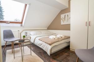 a bedroom with a bed and a desk and a window at Ruby restoran & prenoćište in Nova Gradiška