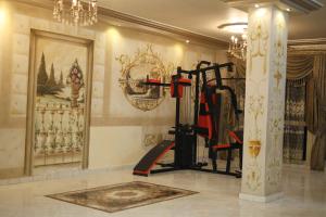 a gym with a treadmill in a room at Royal palace in Kafr ‘Işām