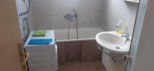 a bathroom with a sink and a shower and a toilet at Porodična kuća in Podgorica