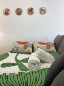 a room with a bed with a towel on it at Bella Sunset Holidays - 3 min da Praia da Mareta in Sagres