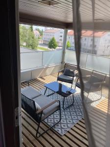 a balcony with chairs and tables on a building at Center Hostel Kaatrahovi in Lieksa