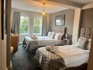 a hotel room with two beds and a window at Laurel Bank Hotel in Markinch