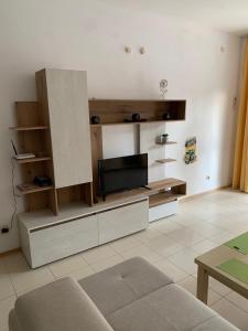 a living room with a flat screen tv on a wall at Harmony Hills Tomovi Apartment H15 in Rogachevo