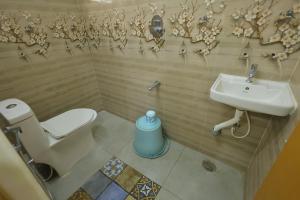 a bathroom with a toilet and a sink at Bhakti Bliss Homestay - 2BHK modern Apartment with AC, Wifi and Android TV in Tirupati