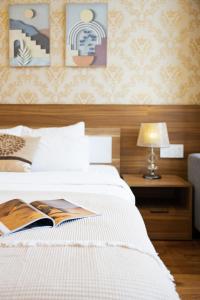 Postel nebo postele na pokoji v ubytování TTR Vincent Hotel